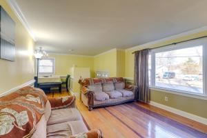 a living room with a couch and a large window at Lorton Vacation Rental Home with Backyard and Deck! in Lorton