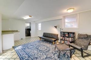 a living room with a couch and a chair at Backyard and Deck Family-Friendly Lorton Home! in Lorton