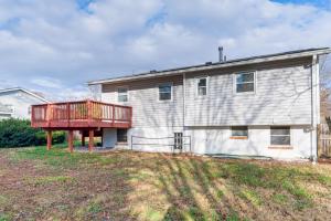 a house with a deck on the side of it at Backyard and Deck Family-Friendly Lorton Home! in Lorton