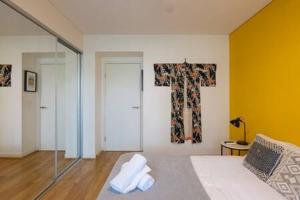 a living room with a couch and a cross on the wall at Treetops Erskineville Apartment w Parking & Aircon in Sydney