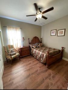 a bedroom with a bed and a ceiling fan at King Suite & Jacuzzi Luxe Getaway in Port St Lucie in Port Saint Lucie