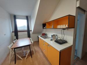 a small kitchen with a table and a counter top at VV way - Lisica zvitorepka in Ljubljana