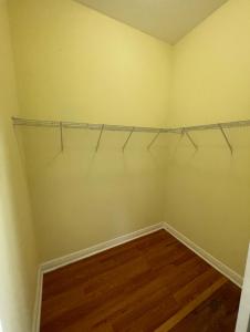 an empty room with a closet with wooden floors at King Suite & Jacuzzi Luxe Getaway in Port St Lucie in Port Saint Lucie