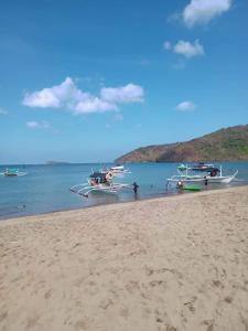 a group of boats sitting on the beach at llaves trancient 3 in Nasugbu +2 photos