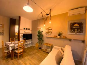 a living room with a couch and a dining room at Silent Bay Apartments in Sestri Levante