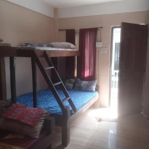 a room with two bunk beds and a window at llaves trancient 3 in Nasugbu