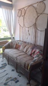 a large couch sitting in a room with a window at Casa Magia in Bombinhas