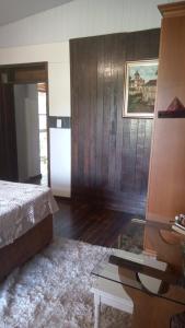 a bedroom with a bed and a table in it at Casa Magia in Bombinhas