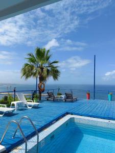 a swimming pool with a view of the ocean at Riad Ras Lafaa in Safi