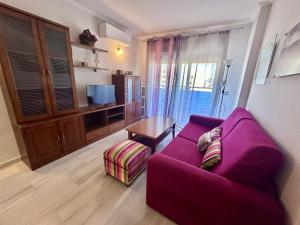 a living room with a purple couch and a table at A906 Alkadir 2004 Finestrat in Villajoyosa