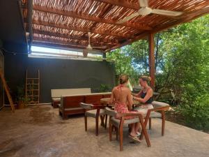 two women sitting at a table in a patio at L2 Bacalar in Bacalar