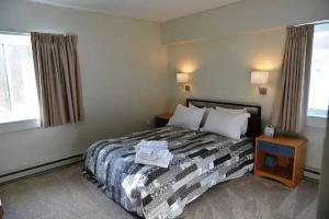 a hotel room with a bed and a window at Mt Green, Pool, Gym, Sauna, Hot Tub Open 3br2b, in Killington