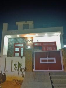 a house with a red garage at night at Kishore villa fully furnished house in Jaipur
