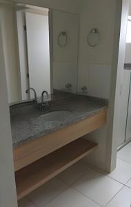 a bathroom with a sink and a large mirror at Thermas Do Bosque By Bnbhost in Caldas Novas