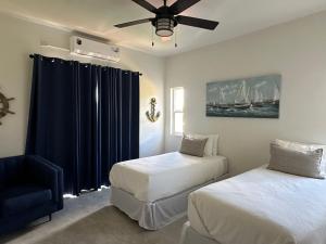 a bedroom with two beds and a ceiling fan at Belle La Maye Bed and Breakfast Villa in Anse La Raye