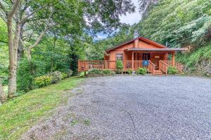 a house with a large driveway in front of it at Lazy Creek Retreat in Gatlinburg