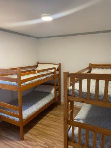 a room with two bunk beds in a room at Eco-Hostel La Casa Verde in Po