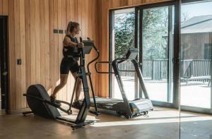 a woman running on a treadmill in a gym at RentUp - Las mejores vistas de San Martin, Volcan Lanin Chapelco y Lago Lacar in San Martín de los Andes