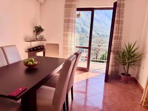 a dining room with a table and chairs and a window at KOALA 3 in Trstenik