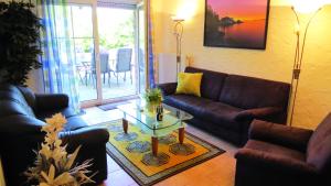 a living room with a couch and a table at Wellness Apartments Sophienhöhe AM TEICH in Mechernich