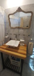 a bathroom with a sink and a mirror at Cuesta pampa casa de campo in Toay
