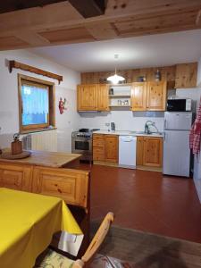 a kitchen with wooden cabinets and white appliances at Chalet Shalom in Livigno