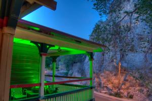 a green building with a mountain in the background at The Inn at Castle Rock in Bisbee