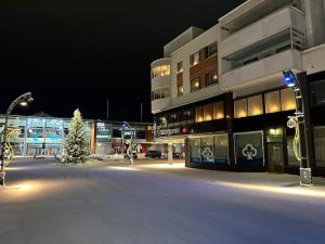 a building with a christmas tree in front of it at Pikku-Utopia - Studio withSauna in Tornio