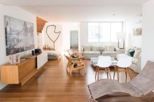 a living room with a couch and a table and chairs at 4 Bedroom Penhouse with Pool in Leblon 012 in Rio de Janeiro