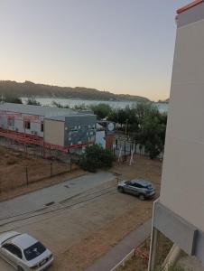 a car is parked next to a train station at DEPARTAMENTO DICHATO in Tomé