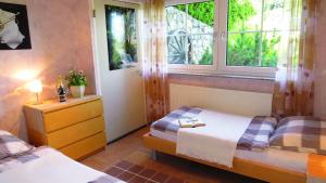 a bedroom with two twin beds and a window at Wellness Apartments Sophienhöhe AM TEICH in Mechernich +20 photos
