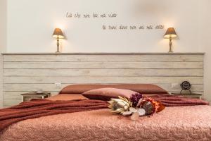 a bedroom with a bed with a quote on the wall at B&B Elianto in Santa Maria Navarrese