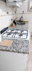 a kitchen counter with a stove top in a kitchen at DEPARTAMENTO COMPLETO 4 Pers Mza in Las Heras