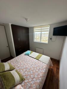 a bedroom with a bed and a window at Apartamento punta Arenas in Punta Arenas