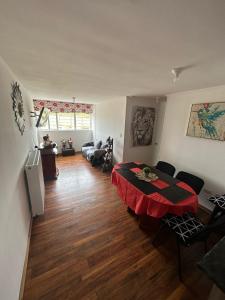 a living room with a table and a couch at Apartamento punta Arenas in Punta Arenas