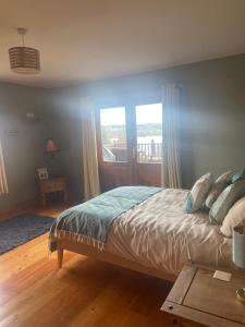 a bedroom with a bed and a window at Fern Lodge. Drumcoura Lake Resort, in Ballinamore