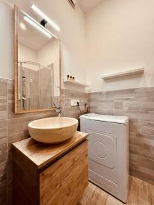 une salle de bain avec un lavabo et une machine à laver dans l'établissement Kibilù - Via Medaglie D'Oro Centro Città con Parcheggio, à Varèse