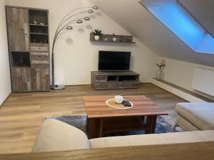 uma sala de estar com uma televisão e uma mesa em Apartmán Putim em Písek