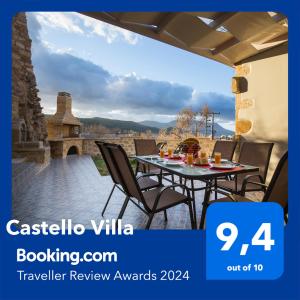 a table and chairs on a patio with a view at Castello Villa - Seaview Villa atop the Venetian Walls in Kissamos