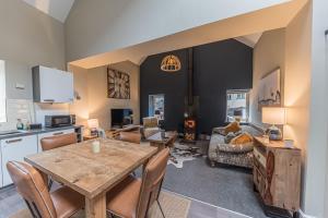a kitchen and living room with a table and chairs at Hodbarrow House in Millom