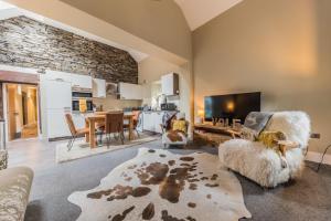 a living room with a couch and a tv at Hodbarrow House in Millom