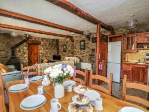 a kitchen and dining room with a wooden table at Y Felin in Llanybydder