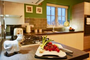 a kitchen with a counter with a plate of fruit on it at Candy Dene, Top Floor Apartment in Swanscombe