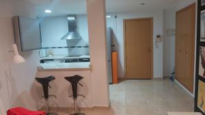 a kitchen with a counter and some black shoes at El estudio de Inma in Burriana