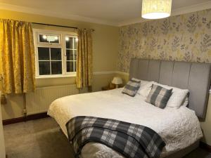 a bedroom with a bed and a window at The George at Donyatt in Ilminster