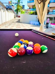 a group of balls on a pool table at Hotel Barmoi in Freetown