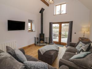 a living room with two couches and a fireplace at The Parlour in Bromsgrove