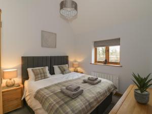 1 dormitorio con 1 cama con 2 toallas en The Parlour, en Bromsgrove