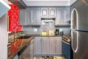 a kitchen with white cabinets and a stainless steel refrigerator at Downtown ATL Condo Walk Score 78 w Free Parking LM1104 in Atlanta