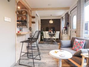 a living room with a couch and a table at Chalet Forte in Aberdyfi +24 photos